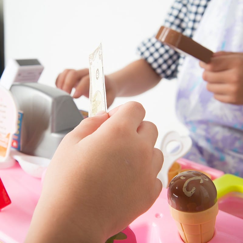 little boy playing pretend ice-cream shop