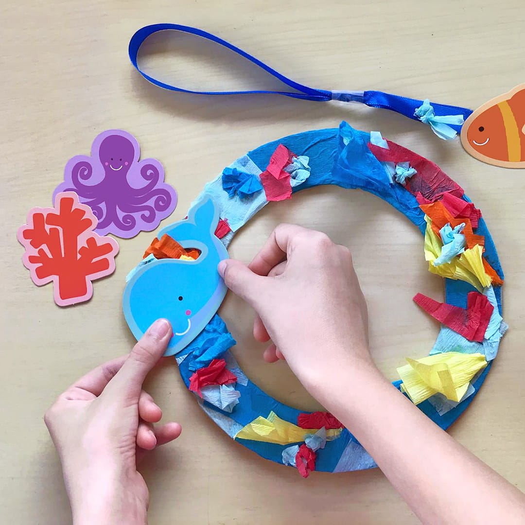 Kid making ocean-themed craft