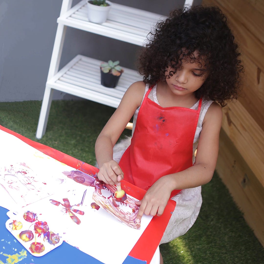Girl painting with bug-themed stencils