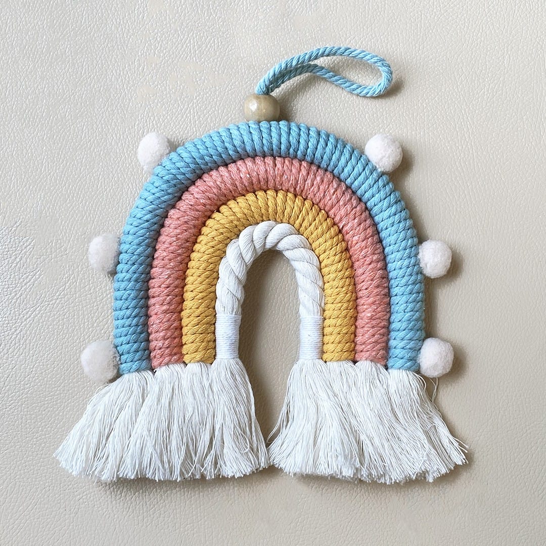 Decorative macrame rainbow with pom-poms