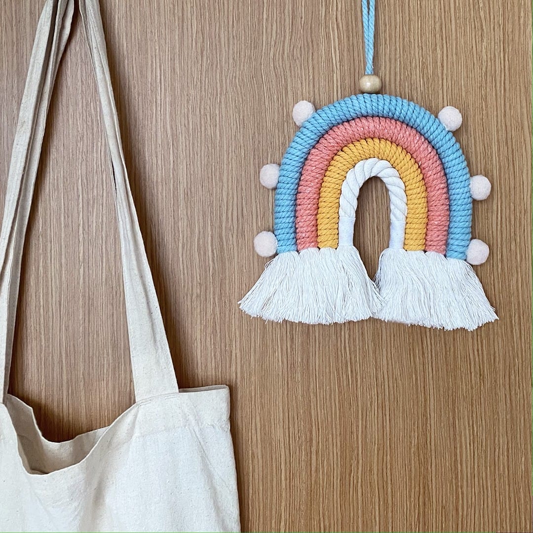 Decorative macrame rainbow with pom-poms